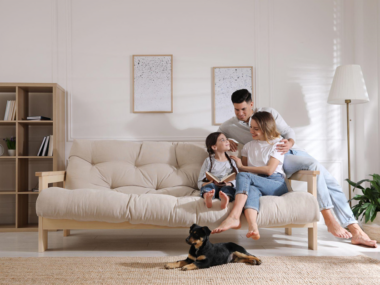 Happy family on sofa with puppy